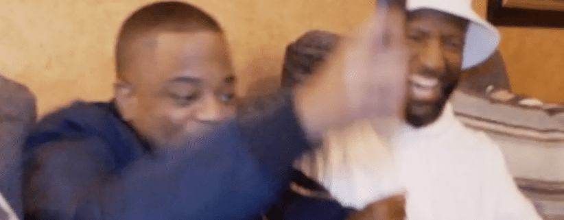 Two people smiling and gesturing excitedly.